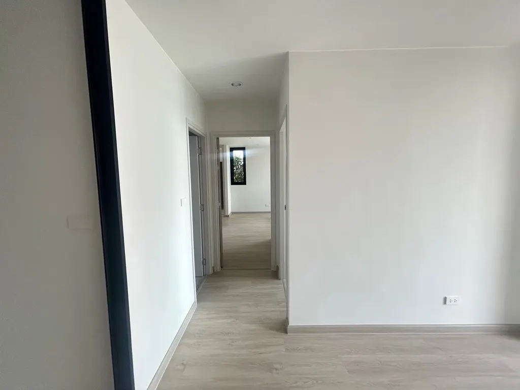 Living room (view 2) of the 2-bedroom condo (59.9 sq.m.) at Thana Astra Sathorn-Chan